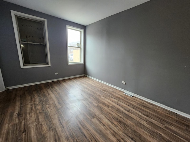 unfurnished room with dark hardwood / wood-style floors