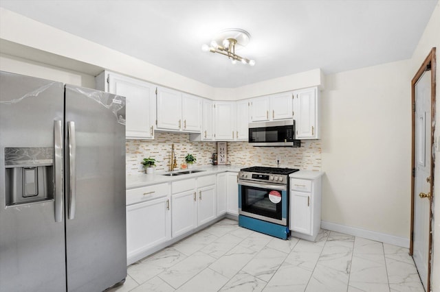 kitchen featuring decorative backsplash, white cabinetry, sink, and appliances with stainless steel finishes