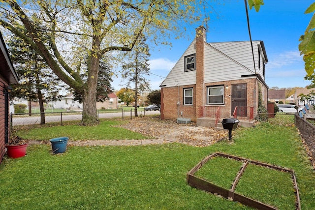 rear view of property featuring a yard