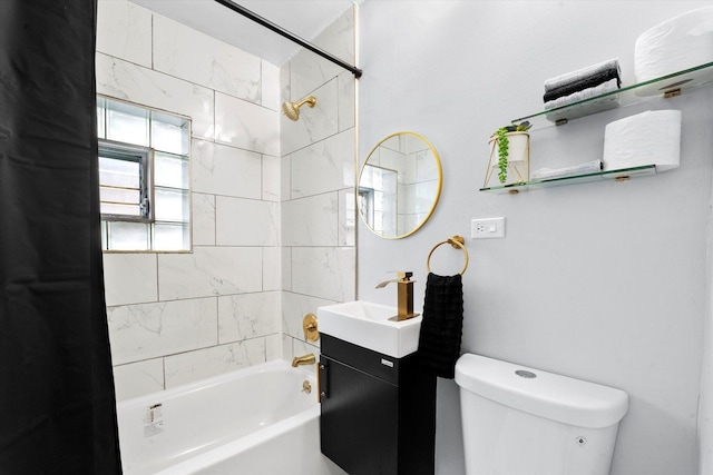 full bathroom with toilet, vanity, and tiled shower / bath