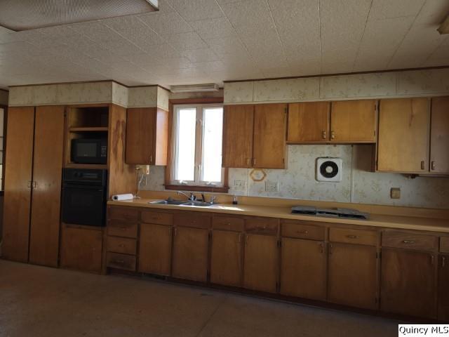 kitchen with sink and black appliances