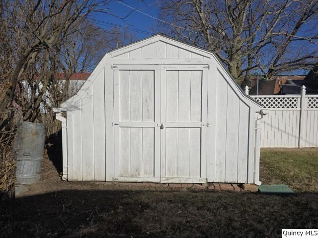 view of outdoor structure featuring a lawn