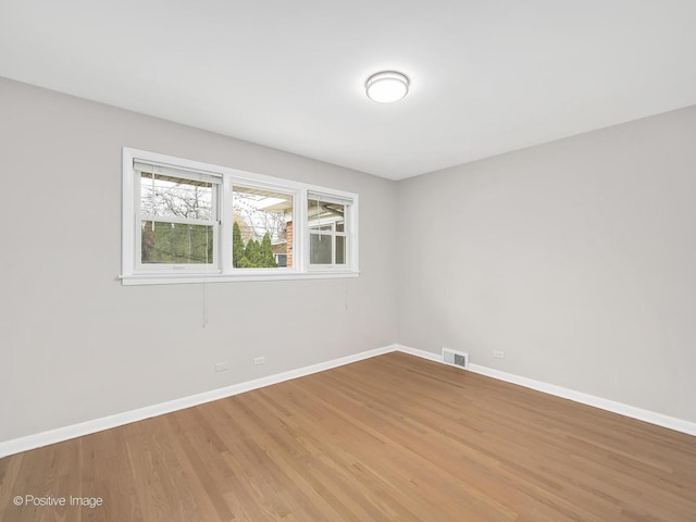 unfurnished room featuring hardwood / wood-style flooring