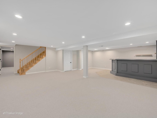 basement featuring light colored carpet