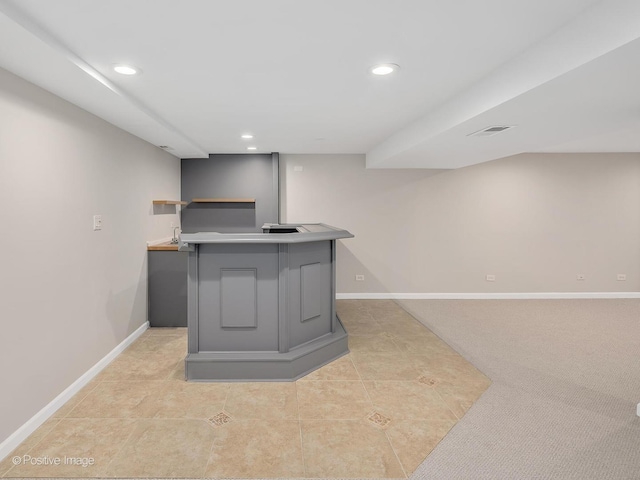 bar featuring gray cabinets and light colored carpet