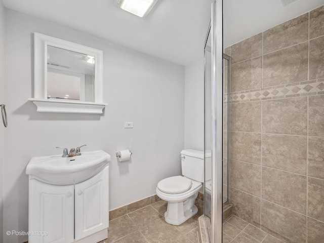 bathroom featuring tile patterned flooring, a shower with door, vanity, and toilet