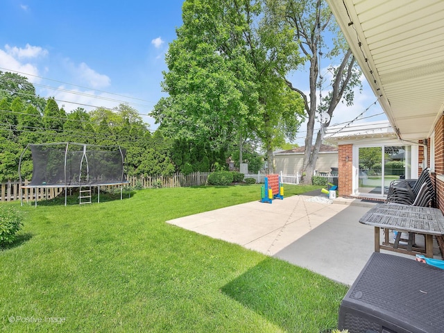 view of yard featuring a patio area and a trampoline