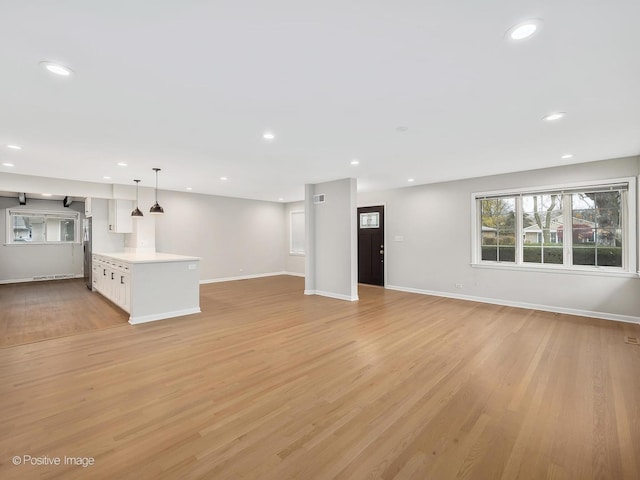 unfurnished living room featuring light wood-type flooring