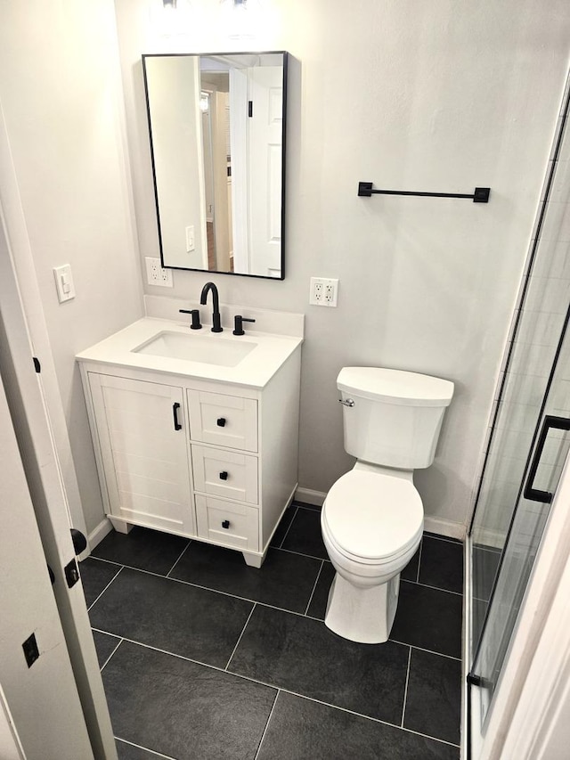 bathroom with tile patterned floors, vanity, toilet, and an enclosed shower