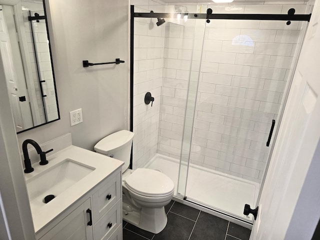 bathroom with tile patterned flooring, vanity, toilet, and a shower with door