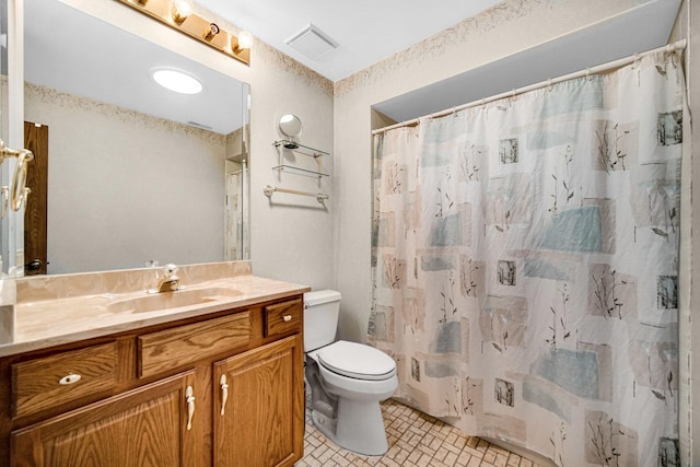 bathroom with vanity, toilet, and walk in shower