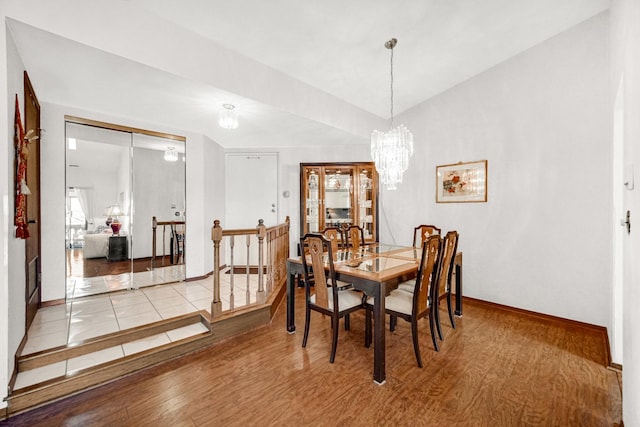 dining space featuring a notable chandelier and light wood-type flooring