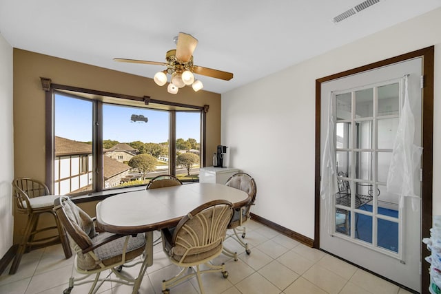 dining space with light tile patterned floors and ceiling fan