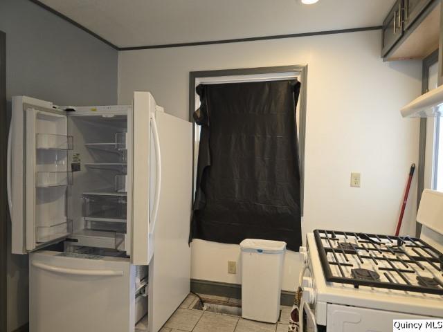 interior space featuring light tile patterned floors and white appliances