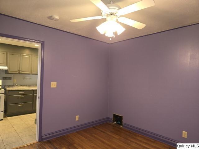 spare room featuring ceiling fan and light hardwood / wood-style floors