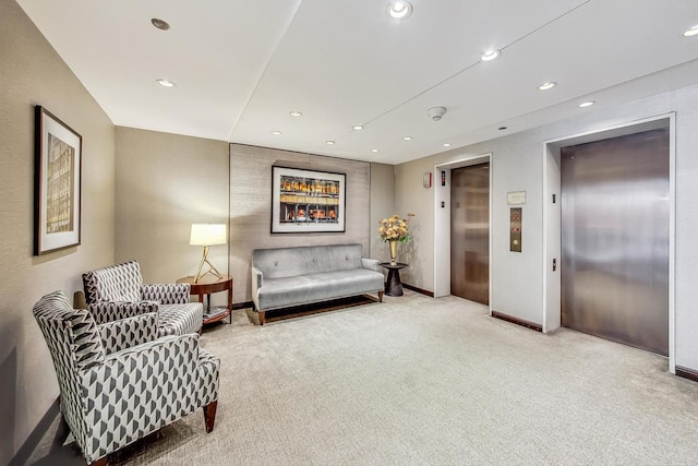 sitting room with elevator and carpet floors