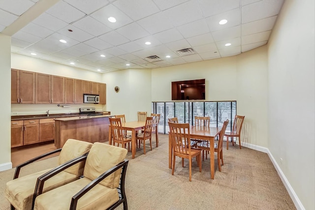 dining room with light carpet