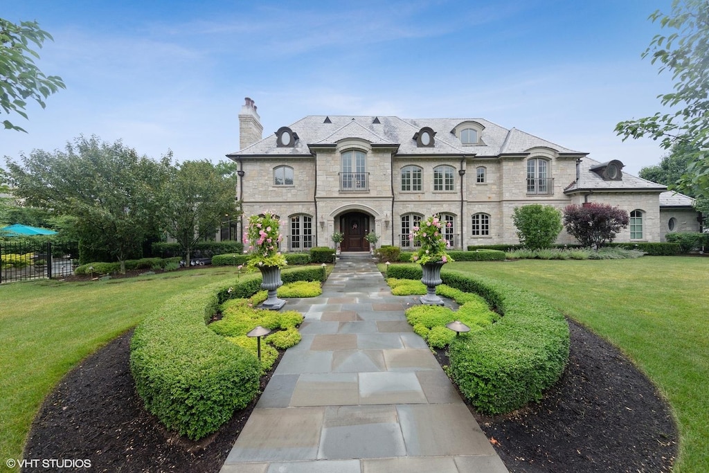 french country home featuring a front yard