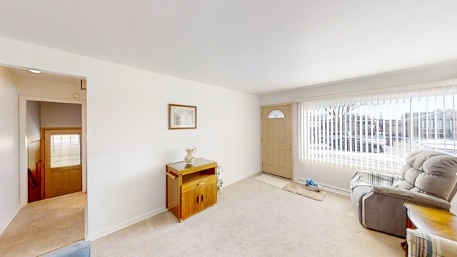 sitting room featuring light colored carpet