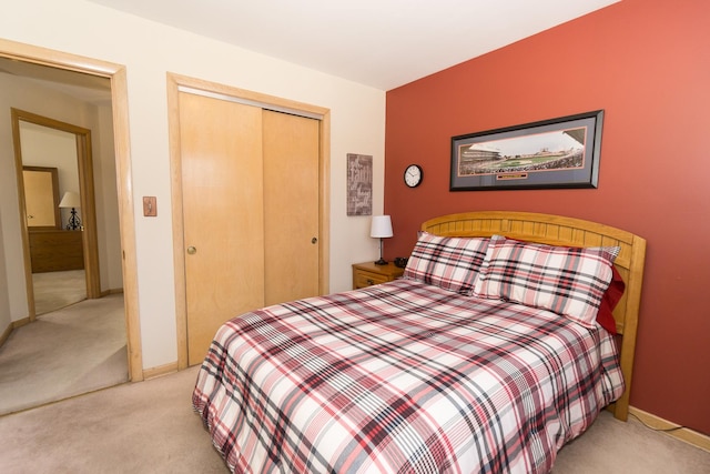 bedroom with a closet and light carpet