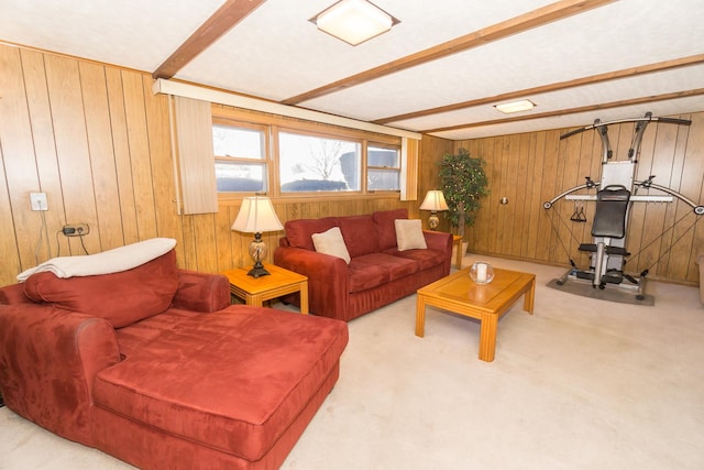 living room featuring wood walls, carpet, and beam ceiling