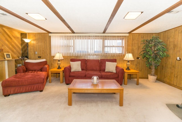 living room featuring carpet floors, wood walls, and beam ceiling