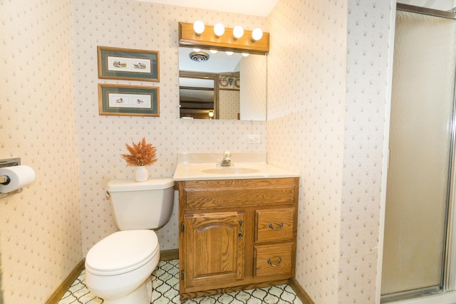 bathroom featuring toilet, a shower with door, and vanity