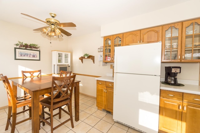 kitchen with ceiling fan, white fridge, and light tile patterned floors