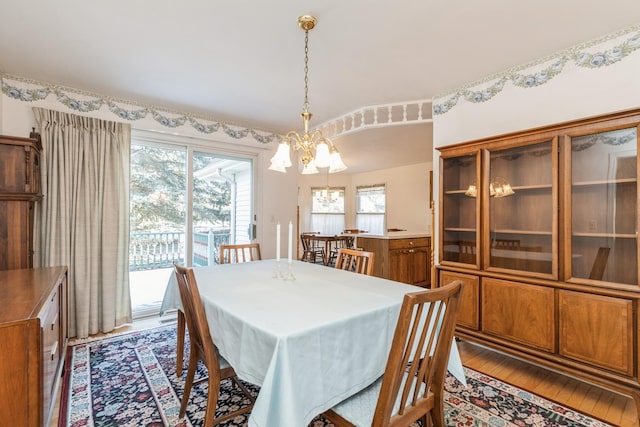 dining room featuring hardwood / wood-style flooring and a notable chandelier