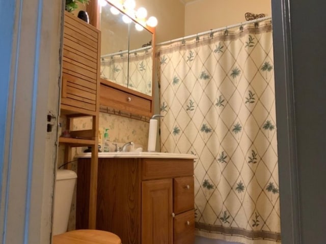 bathroom with vanity, toilet, and walk in shower