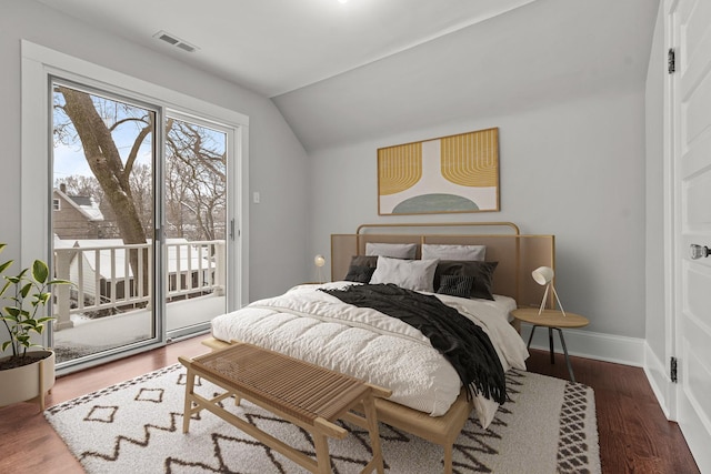 bedroom with lofted ceiling, dark wood-type flooring, and access to exterior