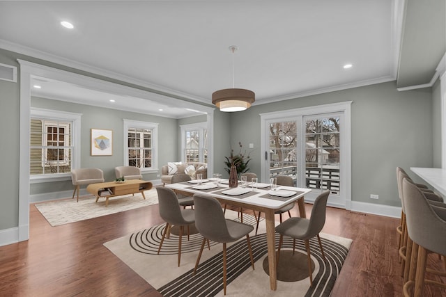 dining area with crown molding and dark hardwood / wood-style floors