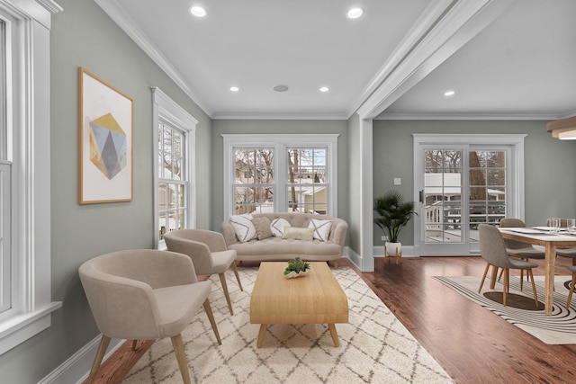 interior space with light hardwood / wood-style floors, a wealth of natural light, and crown molding