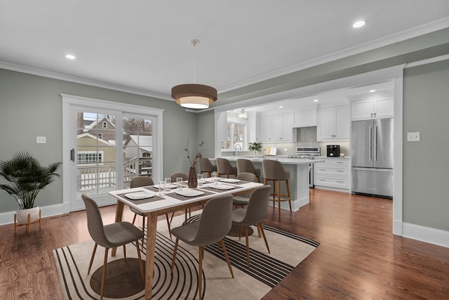 dining room with hardwood / wood-style flooring and ornamental molding