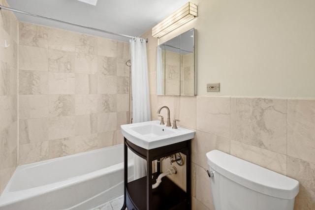 full bathroom featuring toilet, shower / bath combo, tile walls, and sink