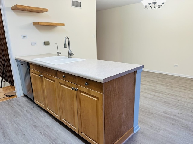 kitchen featuring sink, light hardwood / wood-style floors, and dishwasher