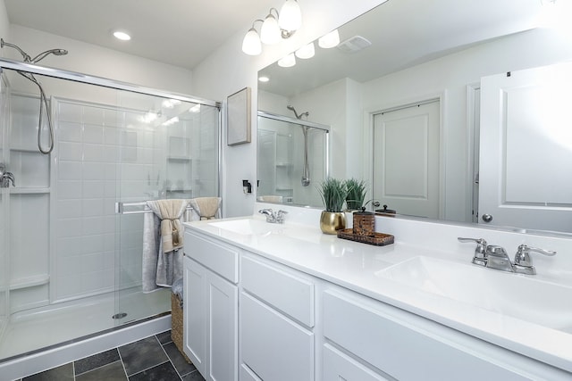 bathroom featuring tile patterned floors, vanity, and a shower with shower door