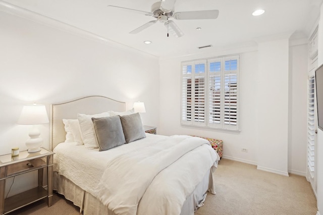 carpeted bedroom with ornamental molding and ceiling fan