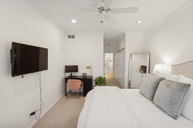 carpeted bedroom featuring ceiling fan, ensuite bath, and crown molding