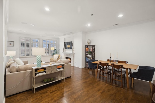 living room featuring dark wood-type flooring and ornamental molding