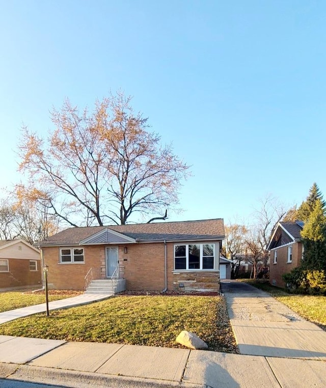 view of front facade with a front lawn and a garage