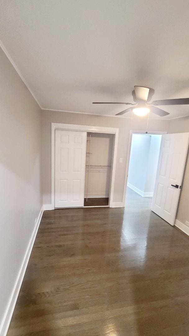 unfurnished bedroom featuring a closet, ceiling fan, and dark hardwood / wood-style floors