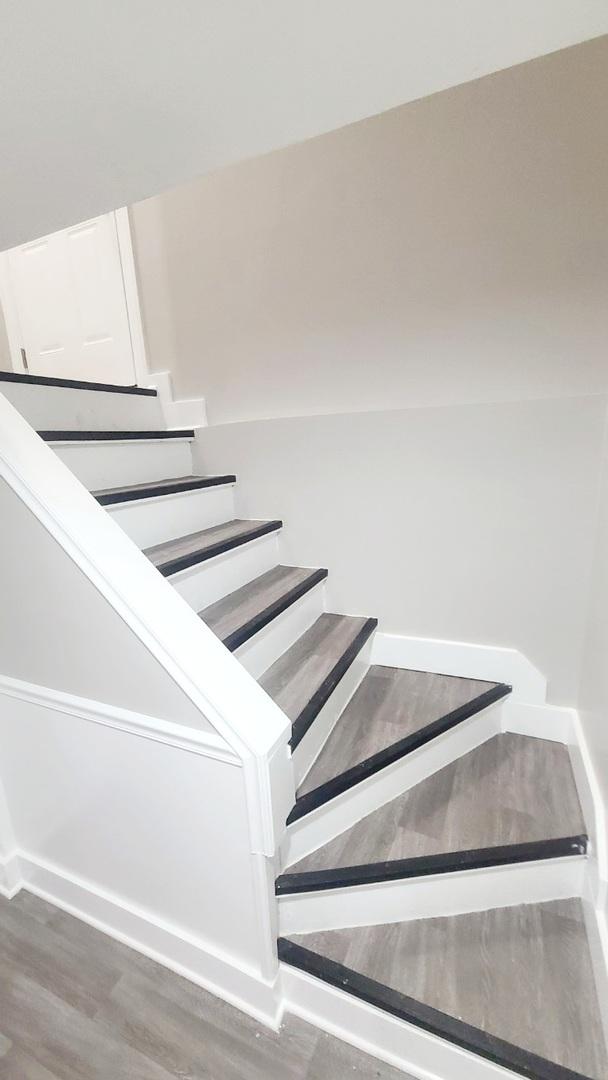 stairs with hardwood / wood-style floors