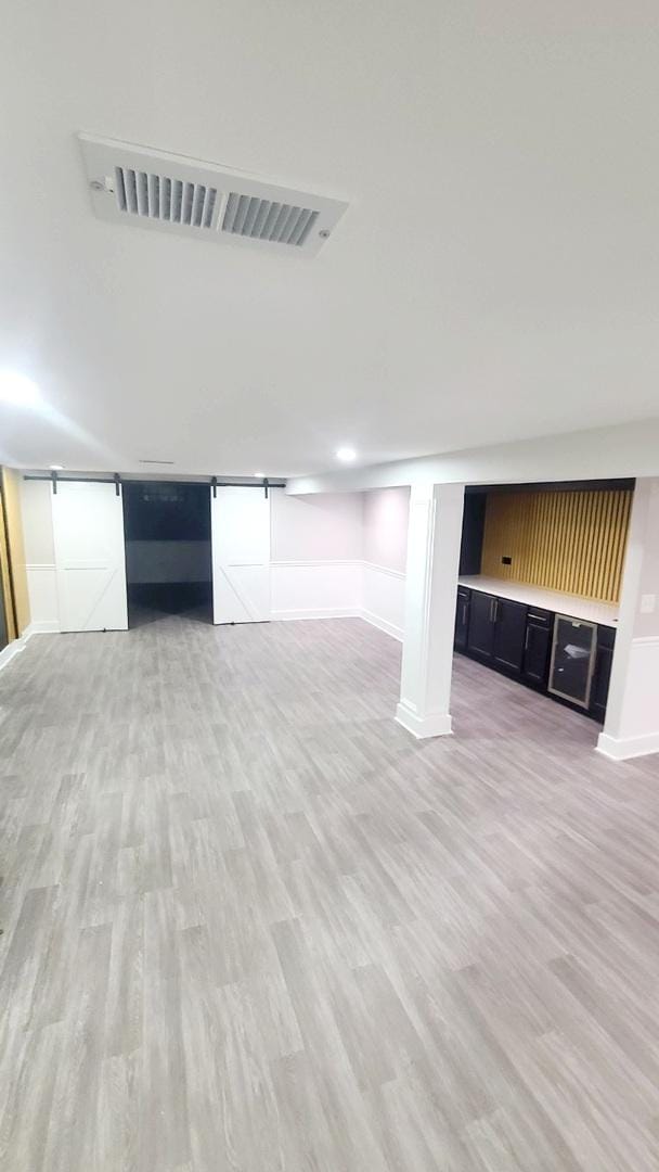 basement with light hardwood / wood-style flooring