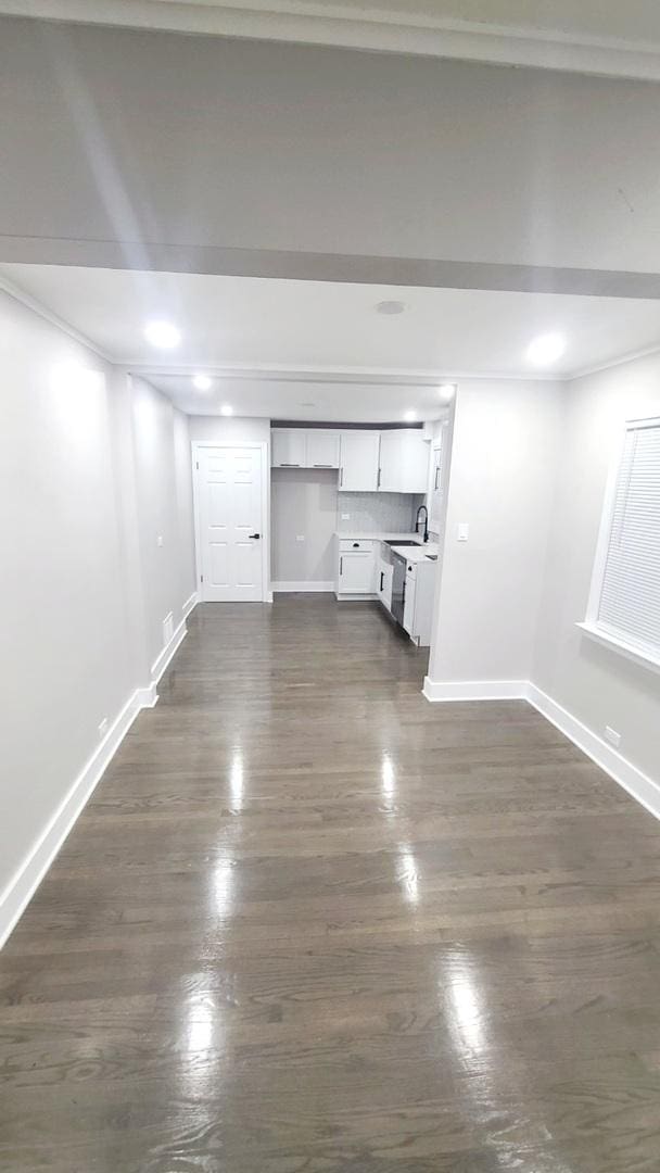 basement featuring sink and crown molding