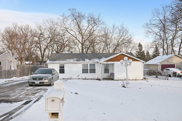 view of front of property with a garage and an outbuilding