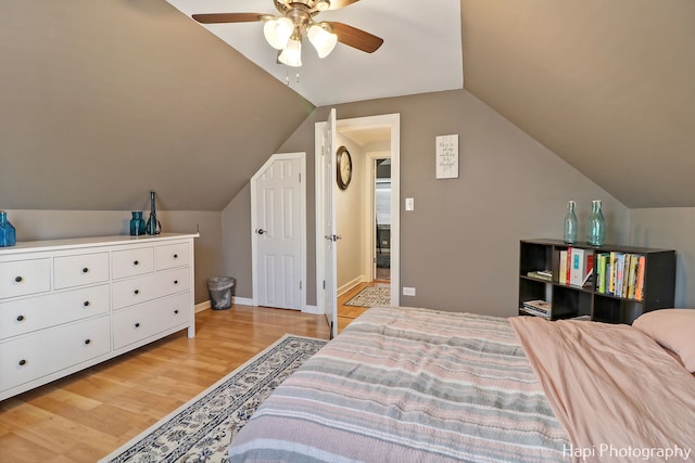 bedroom featuring vaulted ceiling, ceiling fan, and light hardwood / wood-style flooring