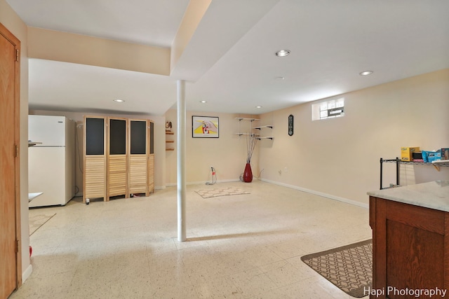 basement with white fridge