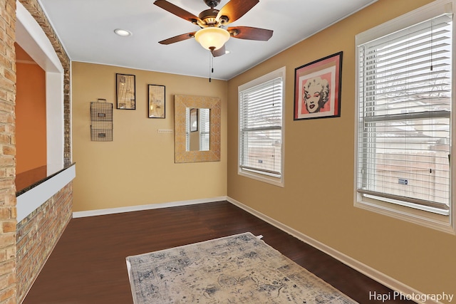 empty room featuring ceiling fan and dark wood-type flooring