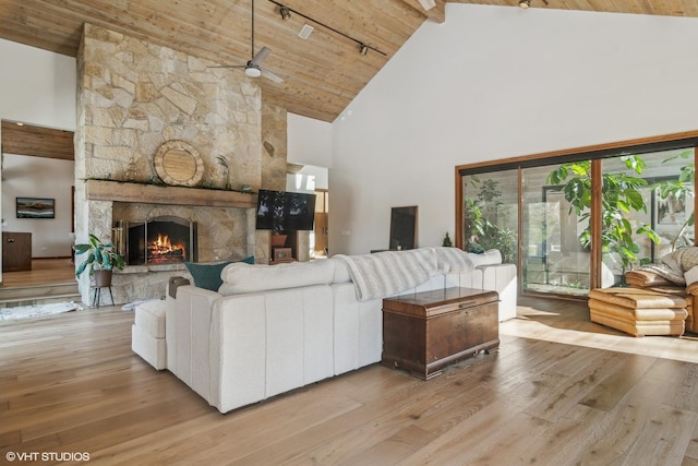 living room with high vaulted ceiling, a fireplace, wood ceiling, and light hardwood / wood-style flooring